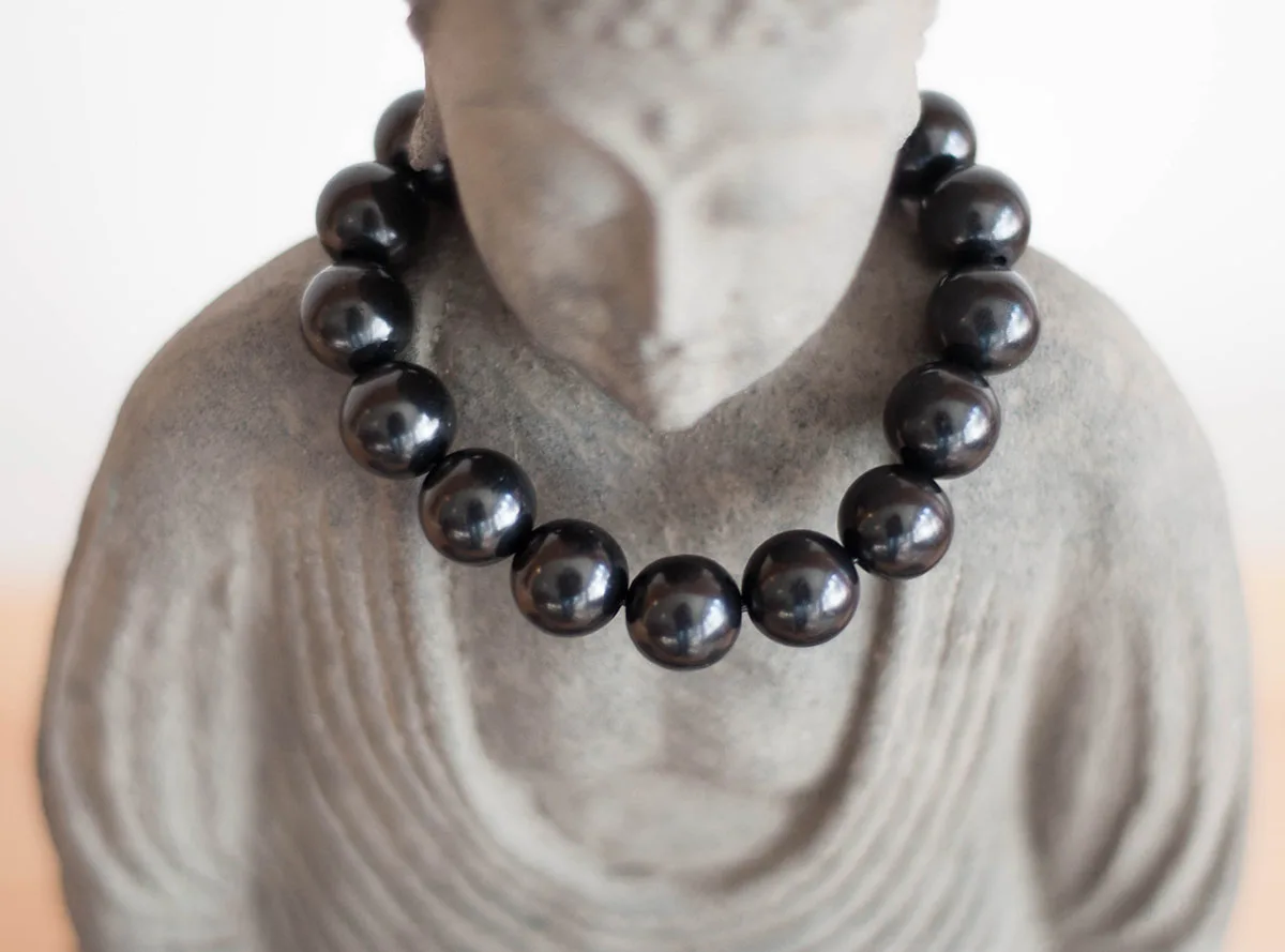 Shungite beads on buddha